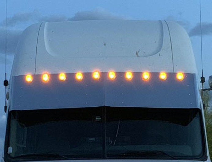 Visor 18" Freightliner Cascadia Condo / Mid Roof. Custom w/ (10) 2" light cut out Across the Top Evenly Spaced.